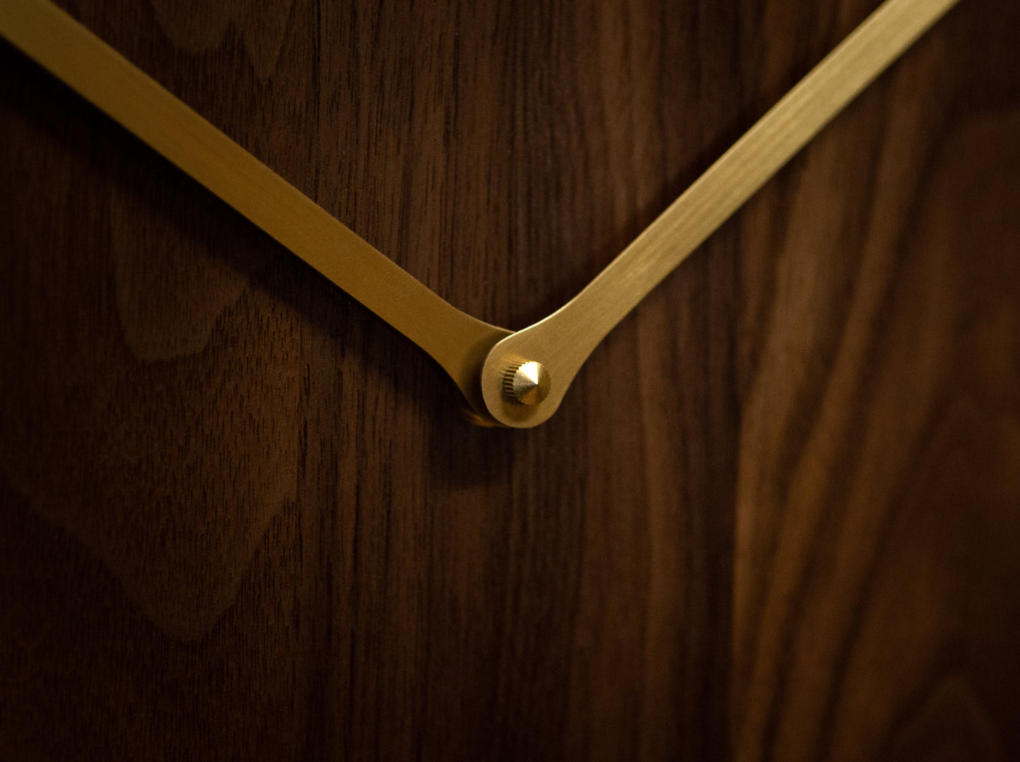 hickory wooden clock close up of brass clock hands