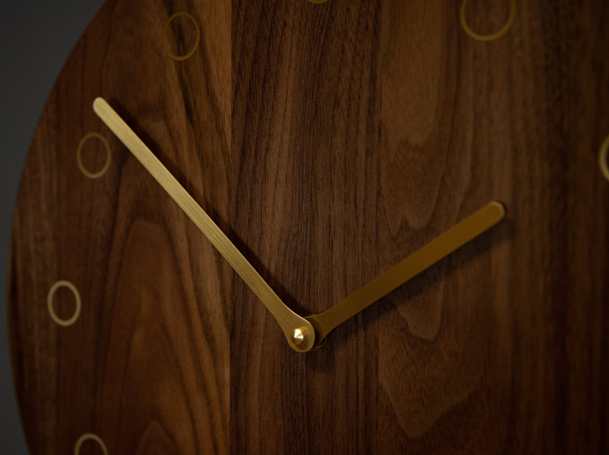 hickory wooden clock close up of brass clock hands and accents